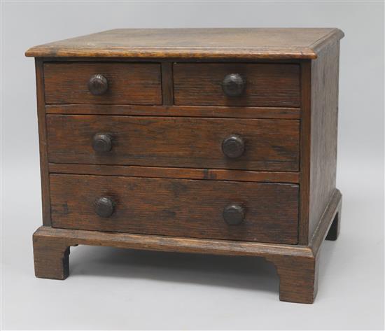 An oak miniature chest of drawers